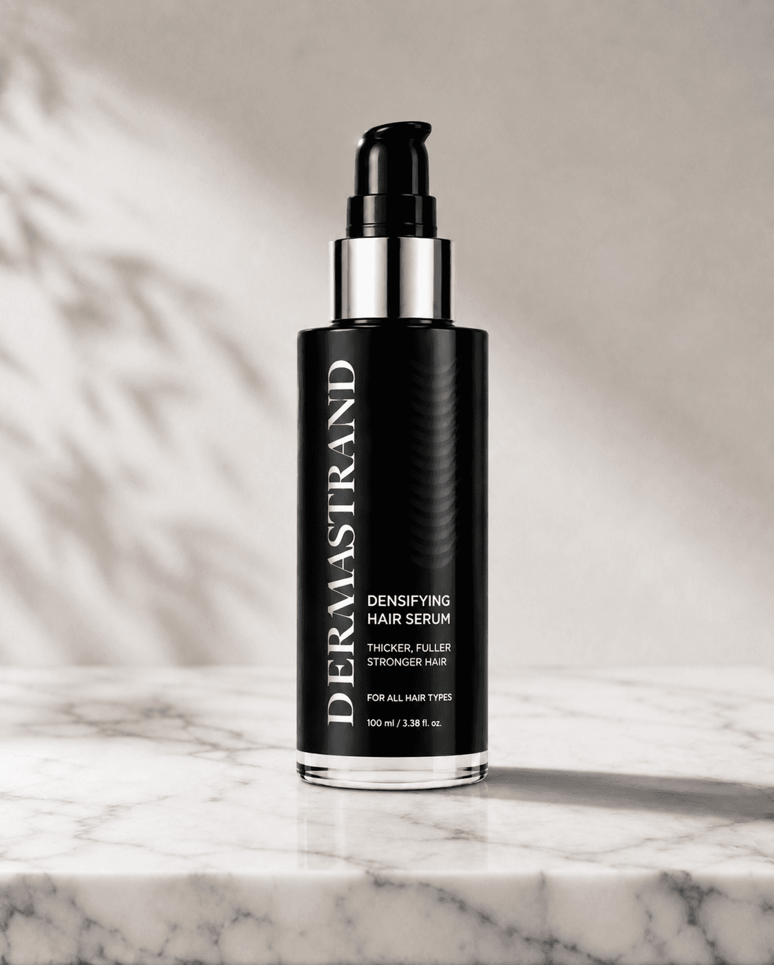 DERMASTRAND densifying hair serum on a marble surface