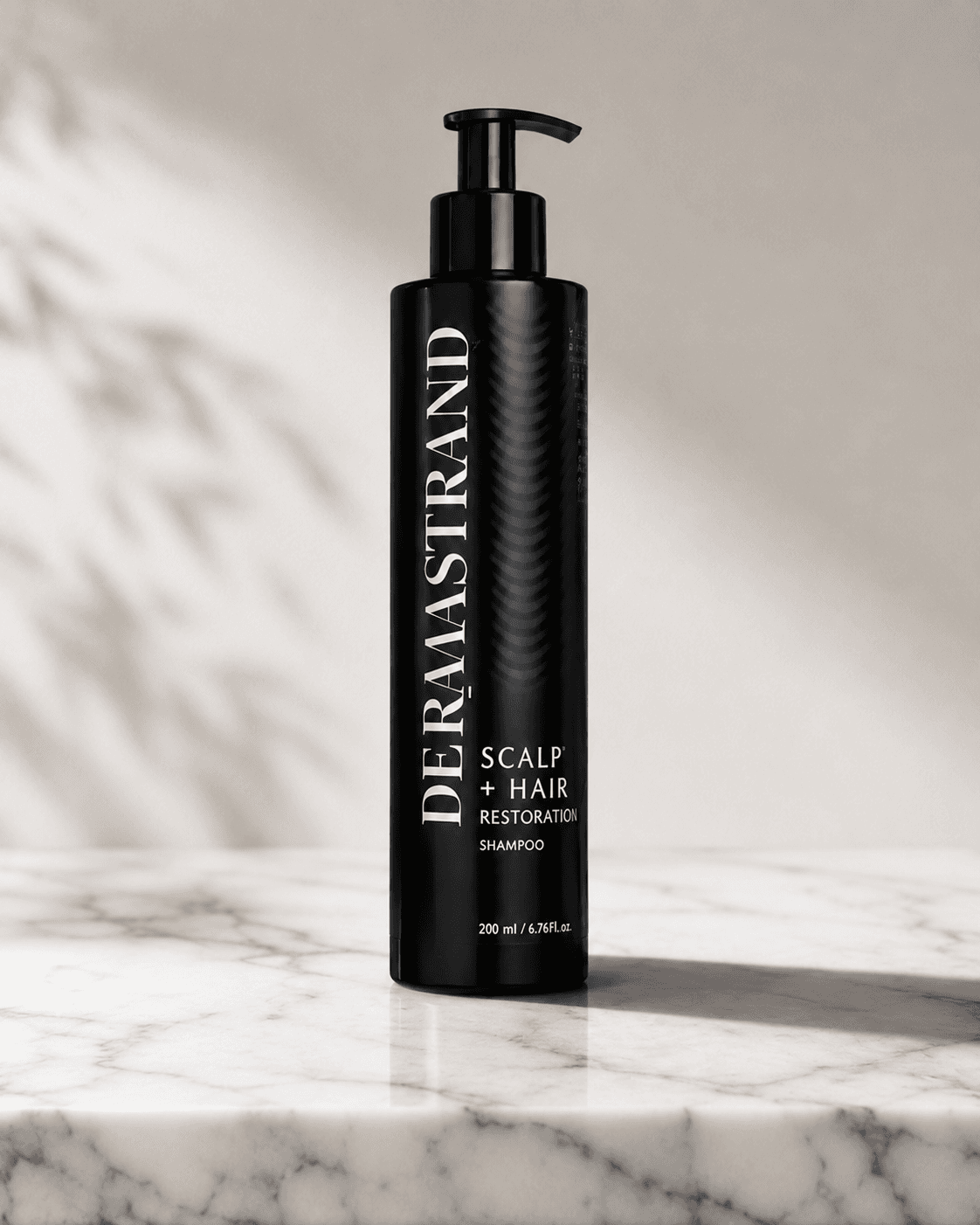 DERMASTRAND restoration shampoo on a marble surface